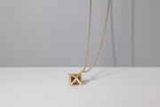 Todd Reed necklace made with 18k yellow gold, Octahedron diamond (~24.97ct), and white brilliant cut diamonds (~.98ct)
